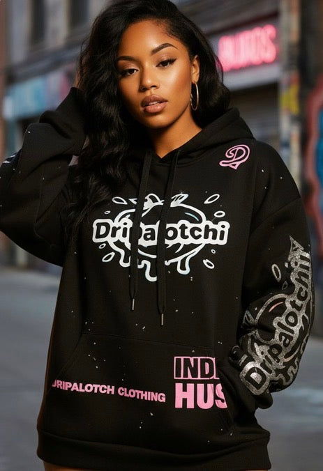 Person wearing a black hoodie with brand logos in an urban setting